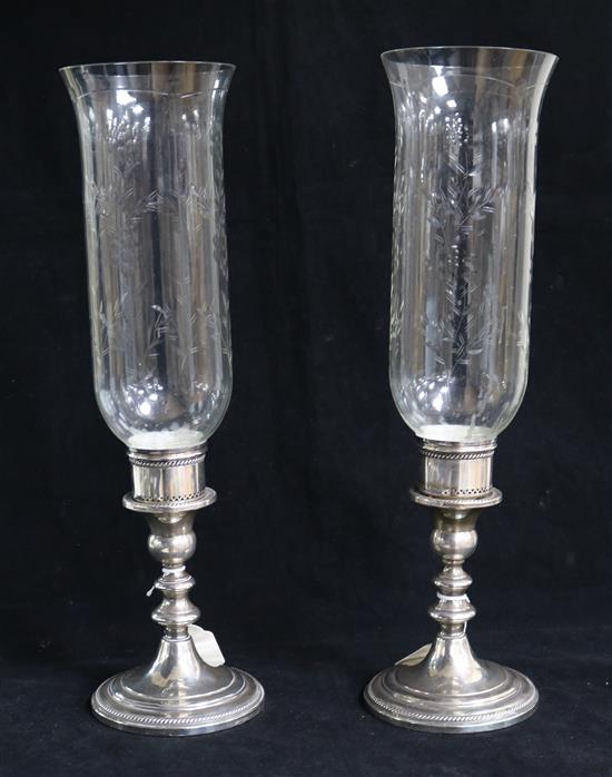 A pair of sterling silver mounted glass storm shades, 41.5cm.